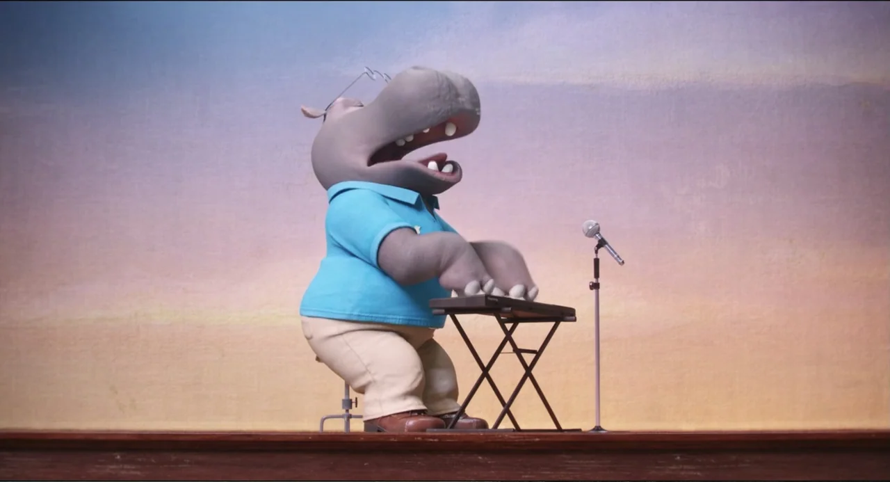 Sing (2016) movie still: fullbody — A stylized anthropomorphic hippopotamus stands before a gradient wall in a clean studio space. The character…