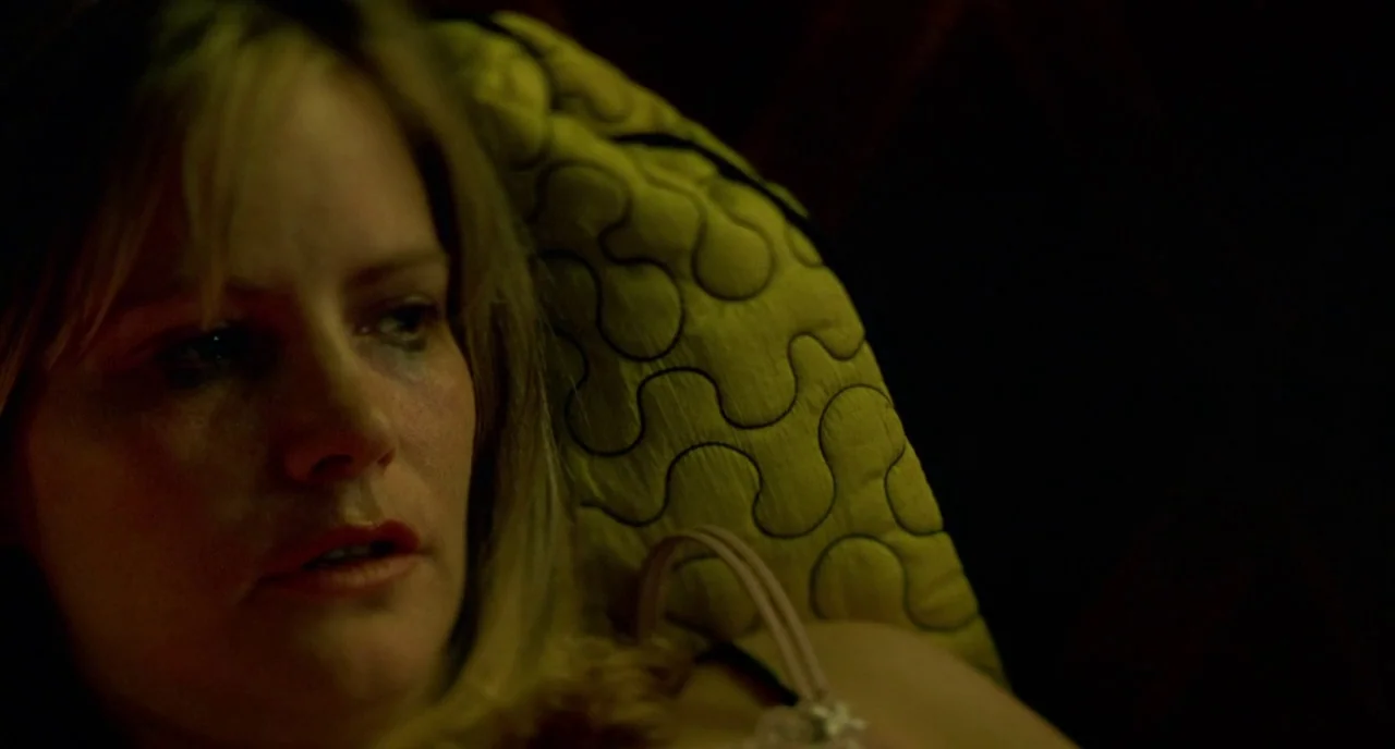 In The Cut (2003) movie still: closeup — A dimly lit room at night features a person resting against a textured pillow. The subject looks off-camera…
