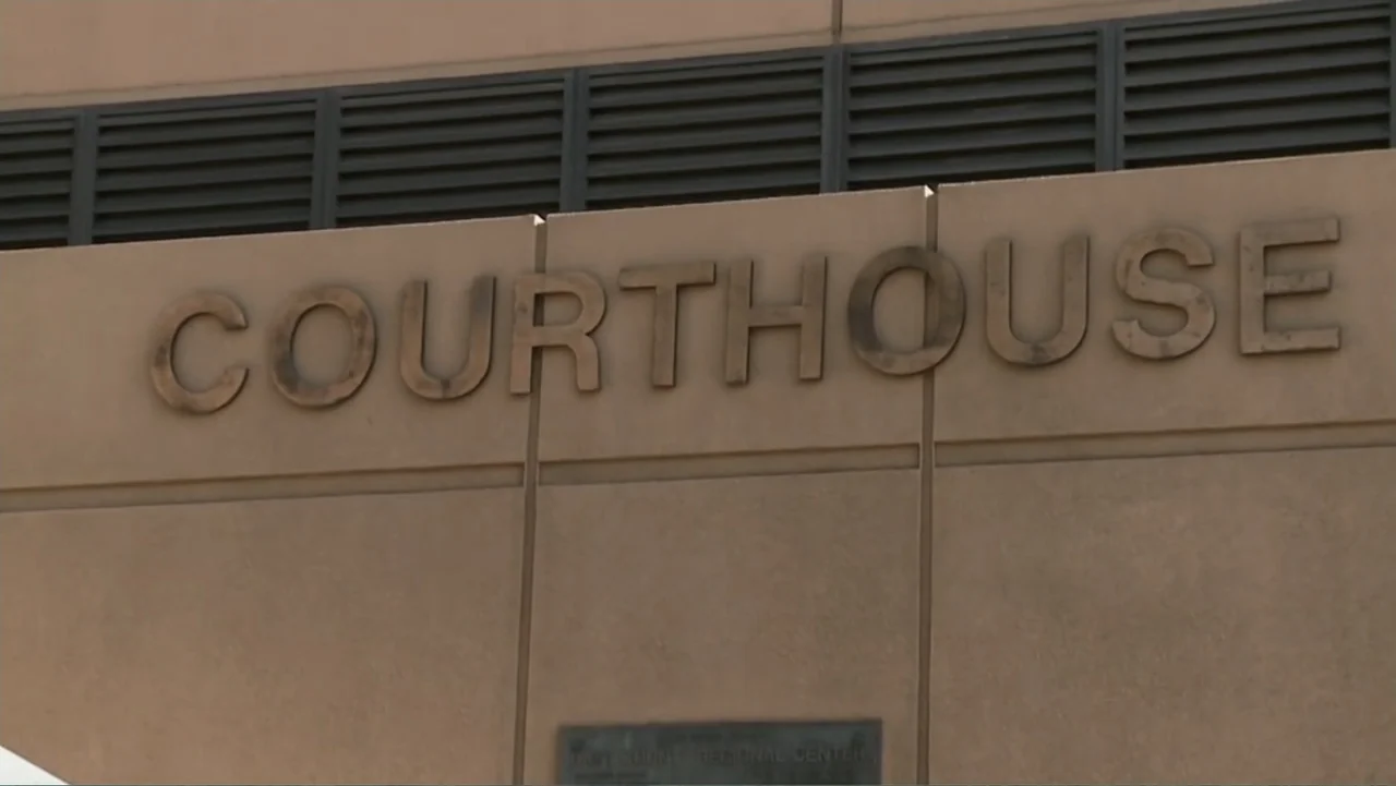 Wartorn: 1861-2010 (2010) movie still: establishing — A tan concrete exterior wall features large metal lettering spelling the word courthouse.…