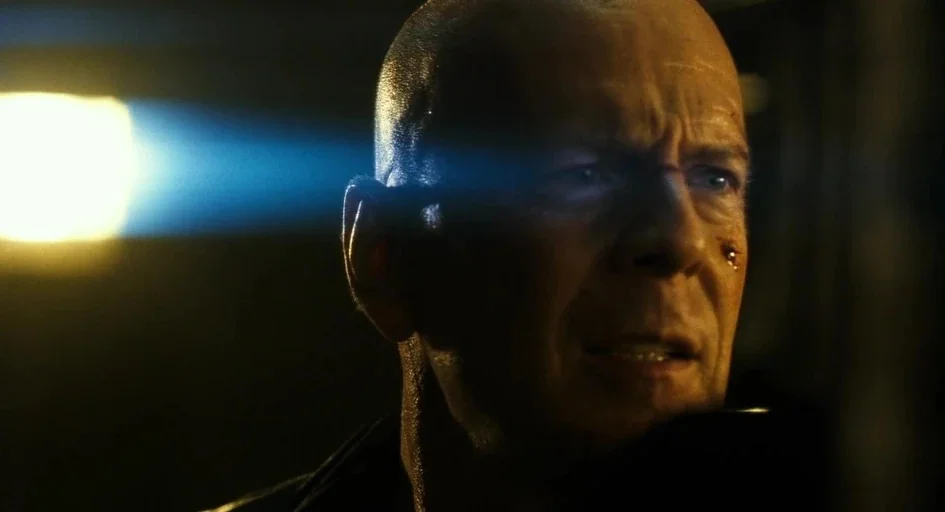 A Good Day to Die Hard (2013) movie still: closeup — A dark environment surrounds a man's face illuminated by a harsh directional beam. He looks…