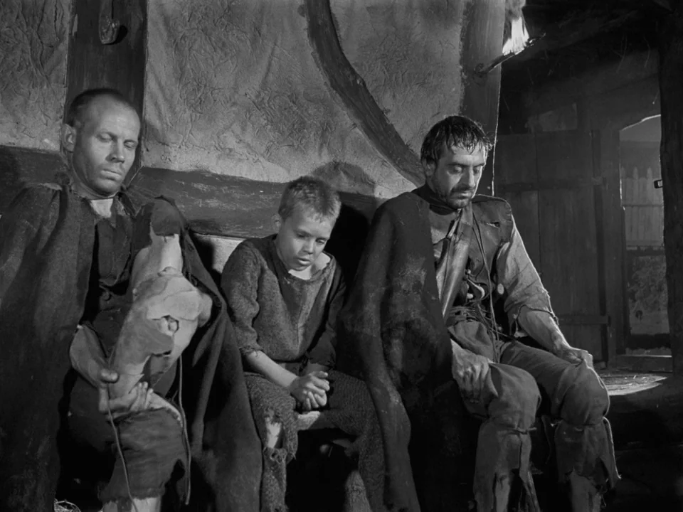 The Virgin Spring (1960) movie still: medium — A rustic interior with textured plaster walls and a wooden bench along the wall. Three people in worn…