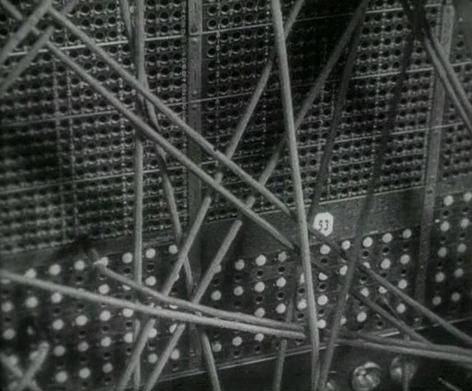 Man with a Movie Camera (1929) movie still: closeup — A vintage telephone switchboard features rows of circular ports and numbered tags. Numerous…