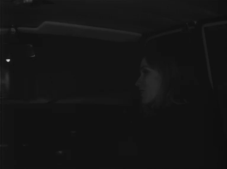My Night At Maud’s (Ma Nuit Chez Maud) (1969) movie still: medium — A dark vehicle interior during the night with extremely limited ambient light. A…