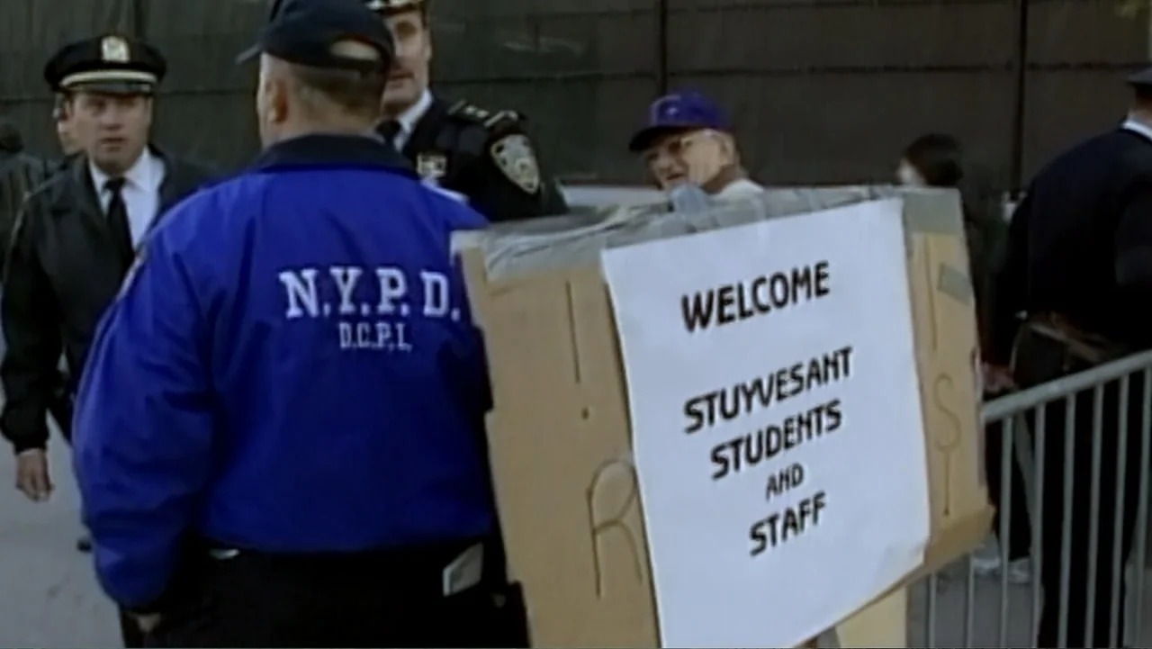 In the Shadow of the Towers: Stuyvesant High on 9/11 (2019) movie still: medium — A sidewalk area features a sign welcoming students and staff near…