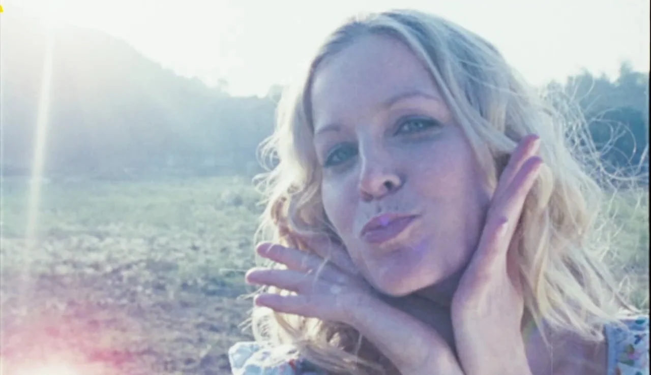 The Devil’s Rejects (2005) movie still: closeup — An open field is visible behind a person during daylight hours with bright sunlight. The person…
