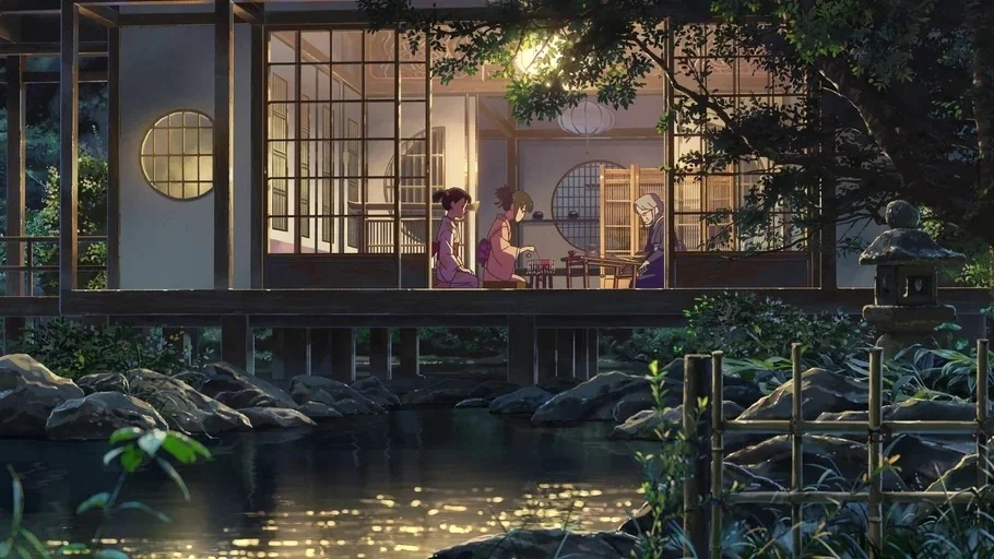 Your Name (2016) movie still: wide — A traditional wooden Japanese house sits beside a reflective stream at dusk. Three women kneel on the porch…