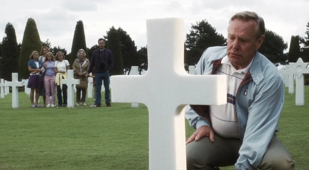 Saving Private Ryan (1998) movie still: medium — A manicured military cemetery featuring rows of uniform white crosses on green grass. An elderly…