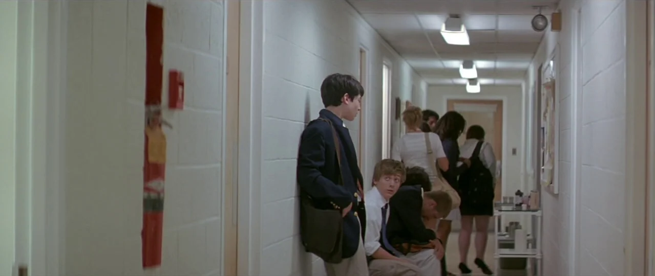 Afterschool (2008) movie still: fullbody — A long school corridor features white cinderblock walls and a series of closed doors. Several teenagers…