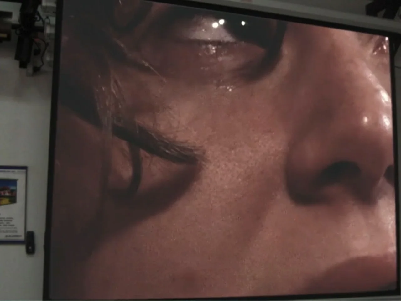 Don't Expect Too Much (2011) movie still: closeup — A close view of a person's face showing skin texture and hair detail. The subject has eyes…