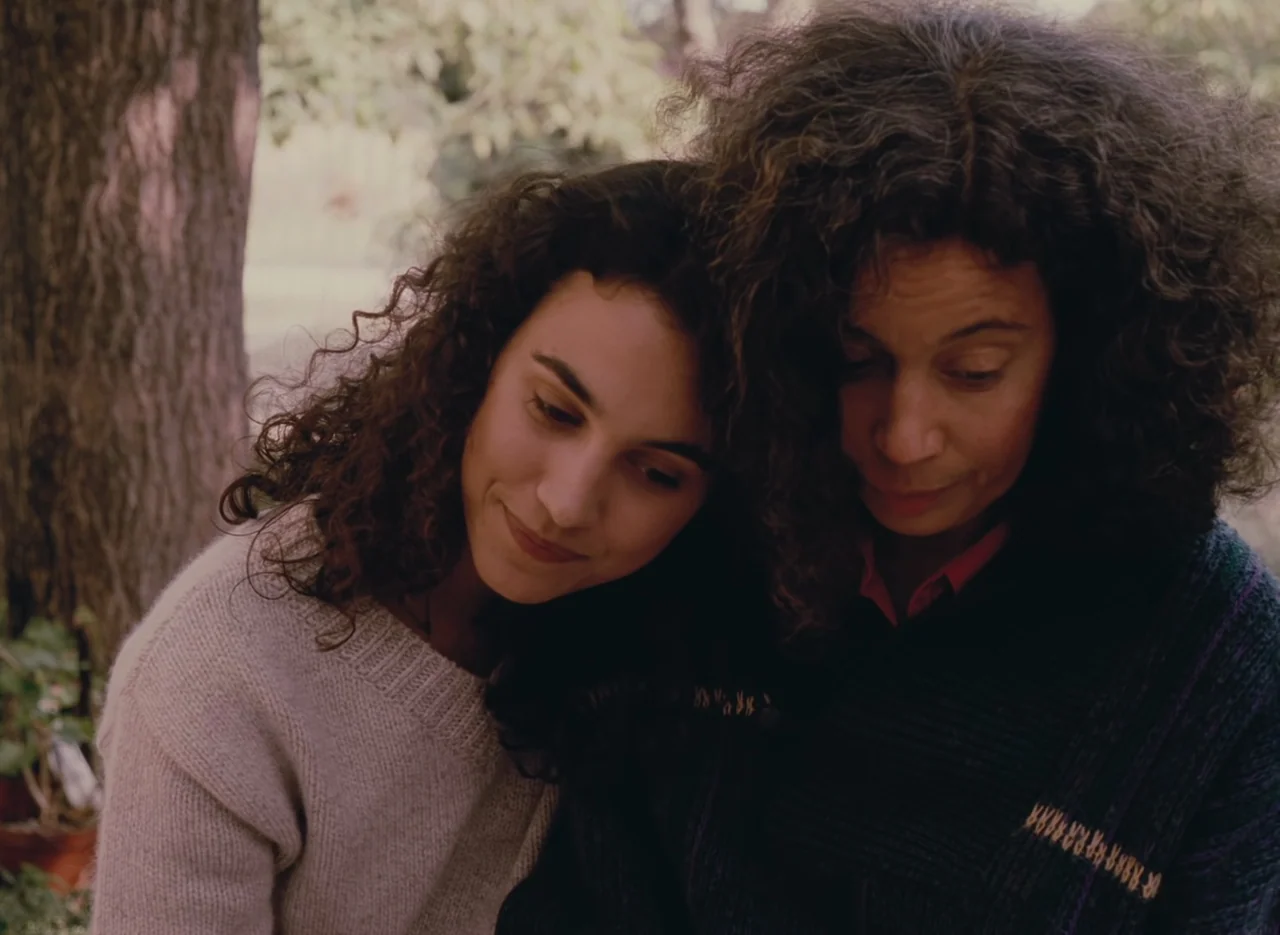 Autumn Tale (1998) movie still: medium — An outdoor setting features two women with curly hair positioned close together. They are situated in front…