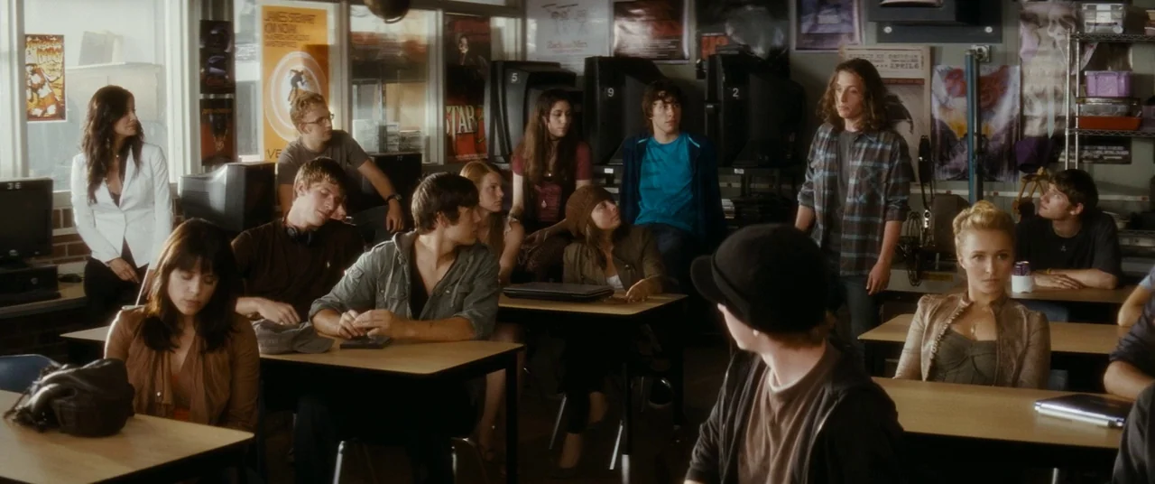 Scream 4 (2011) movie still: wide — A well-lit classroom filled with students sitting at individual desks facing toward the front. Movie posters…