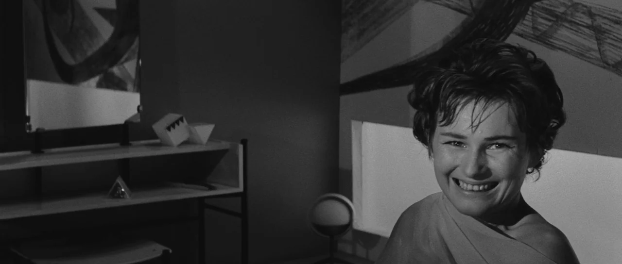 Ikarie XB 1 (1963) movie still: medium — A modern 1960s space featuring abstract wall art and minimalist furniture. A woman with short dark hair…