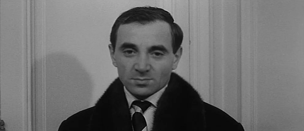 Shoot The Piano Player (Tirez Sur Le Pianiste) (1960) movie still: closeup — A man stands in front of a white paneled door with classical molding.…