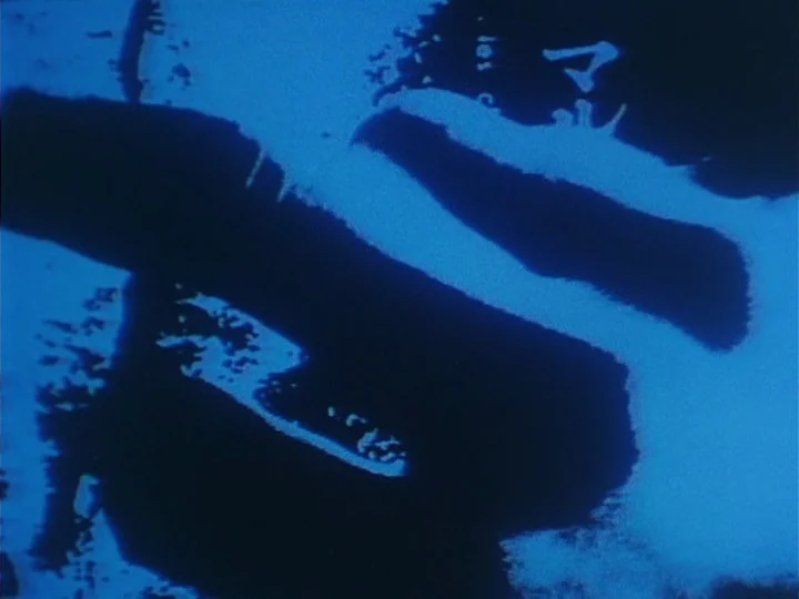 Les Chants de Maldoror (1977) movie still: closeup — Abstract silhouettes occupy the entire frame in a high-contrast monochromatic blue composition.…