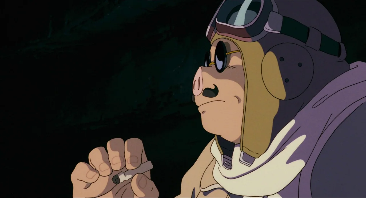 Porco Rosso (1992) movie still: closeup — An anthropomorphic pig character in a pilot's helmet is depicted against a dark background. He holds a lit…